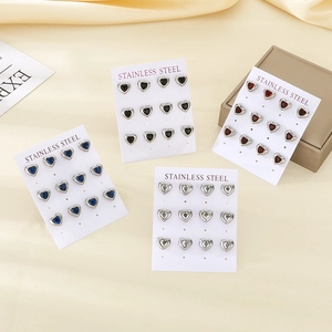 Detail of six pairs heart-shaped stainless steel earrings set with colorful rhinestones