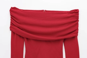 Detailed close-up of off-shoulder neckline and pleated chiffon texture on red blouse