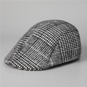 Detail of gray houndstooth wool fabric and stitching on a vintage men's ivy cap