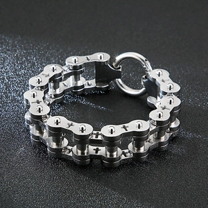 Close-up of a dual-row stainless steel biker chain bracelet with engraved cross details