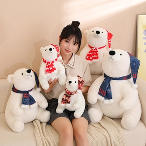 White Christmas polar bear plush toys with knitted scarves in various sizes on a sofa