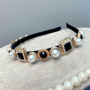 Detail of baroque headband with gold lace metal base, pearls, and black square gemstones
