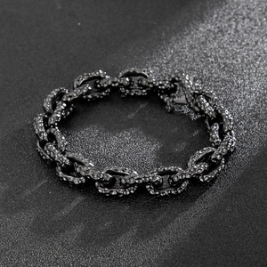 Macro view of men's vintage black chain bracelet with industrial hammered metal texture
