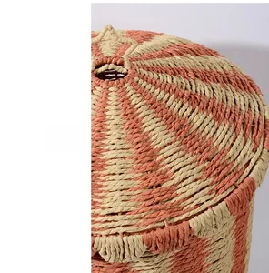Detail of paper rope laundry basket with star handle and orange spiral weave
