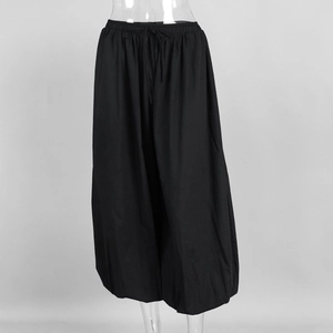 Detail of adjustable drawstring waistband on black cotton loose fit lantern pants
