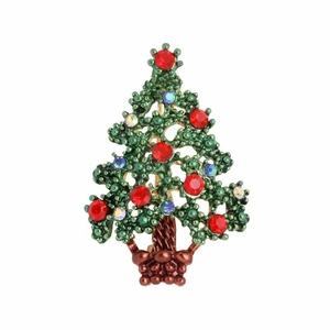 Detailed close-up of green enamel Christmas tree brooch with colorful rhinestones