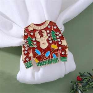 Close-up of a red enamel Christmas sweater napkin ring with rhinestones and reindeer motifs
