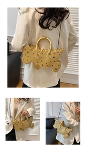 Detail of yellow dinosaur bag with metal rivets and long chain strap on white blazer