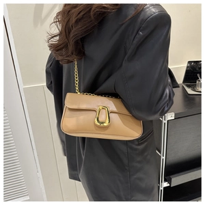 Close-up of khaki leather bag with golden chain strap and trapezoid metal buckle