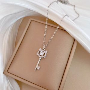 Close-up of cat-shaped key pendant with zircon inlays in a jewelry box