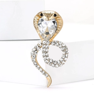 Detail of golden cobra brooch featuring sparkling rhinestones and a large crystal head