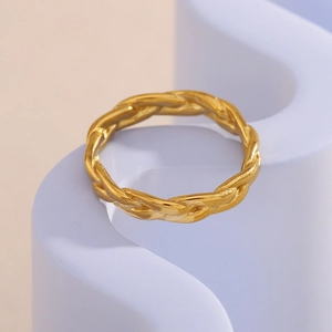 Detail of twisted woven texture on a polished 18K gold-plated stainless steel ring