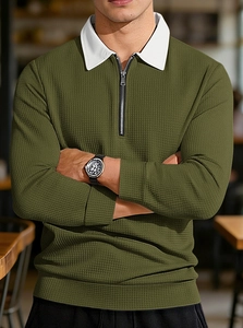 Detail of olive waffle knit polo with white contrast collar and 1/4 zip closure