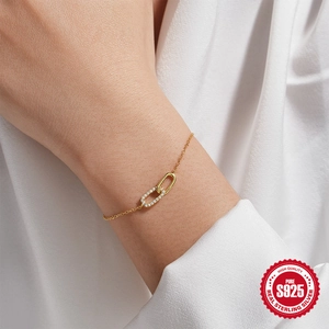 Elegant 925 sterling silver interlocking double loop bracelet with gold plating and zircons