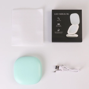Mint green LED makeup mirror set with USB cable and packaging box on white background