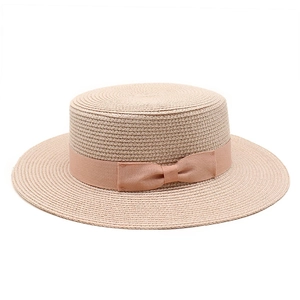 Classic boater straw hat for women with flat top and pink ribbon bow on white background