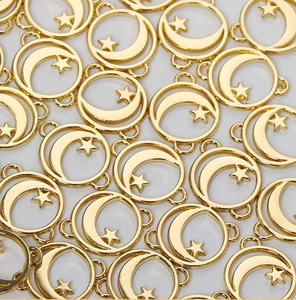 Detailed view of golden alloy moon and star pendants for DIY jewelry crafting