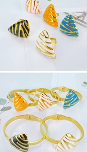 Detail of enameled geometric triangle ring and open bangle bracelet set in gold finish