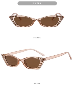 Detail view of tea-colored cat eye sunglasses with rhinestones and gradient lenses