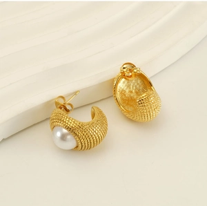 Détail de boucles d'oreilles C plaquées or 18 carats texturées avec perles blanches