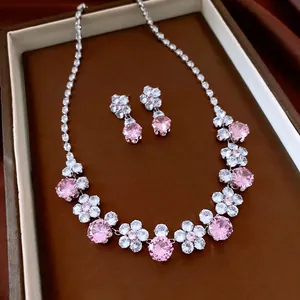 Vintage zircon flower pendant necklace and earrings set on elegant silk tray
