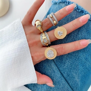 Luxury 18K gold and silver plated rings with zircon stones worn by a model in casual style