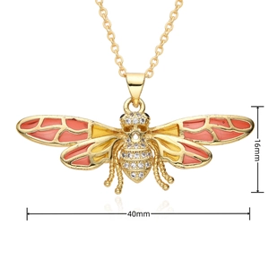 Detailed view of gold plated bee pendant with orange enamel and zircon, 40mm x 16mm size