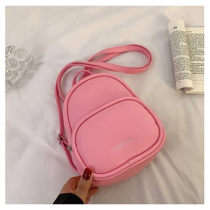 Detailed macro view of small pink PU leather backpack with silver Fashion Bags logo