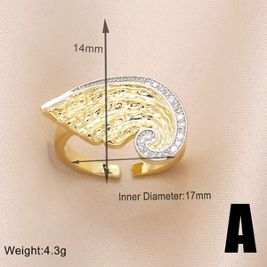 Macro shot showing 14mm width and 17mm inner diameter of gold wing ring with cubic zirconia