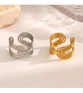 Detail of interlocking gold and silver stainless steel rings on a minimalist white stone background