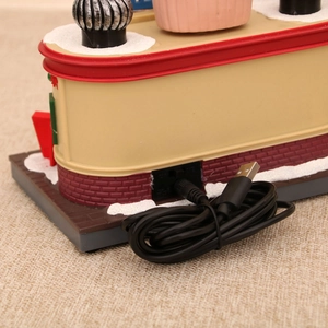 Detail of Christmas music box showing USB power interface and black charging cable cord