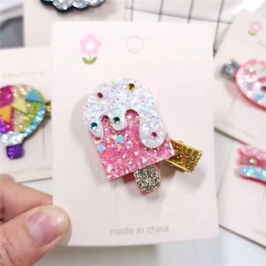 Glittery popsicle hair clip for girls with colorful sparkles on a white display card