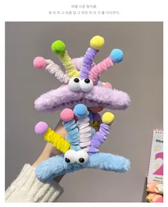 Macro detail of plush shark hair clips with big eyes and colorful spring tentacles