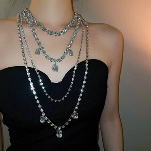 Close-up of layered rhinestone choker with emerald-cut crystals and elegant fringe design