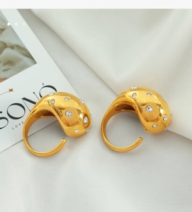 Detailed close-up of 18K gold plated C-shaped hoop earrings with micro-inlaid zircon crystals