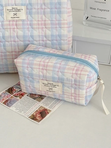 Detail of colorful plaid makeup bags with heart quilting and signature woven label