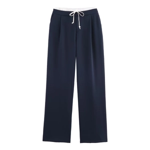 Detailed view of navy blue wide-leg trousers with white drawstring and elastic waistband