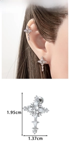 Detailed view of silver cross earring with zircons including size dimensions and on-ear look