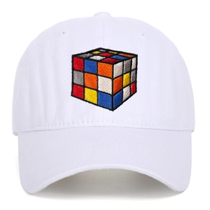 Detailed close-up of colorful cube embroidery on white washed cotton baseball cap