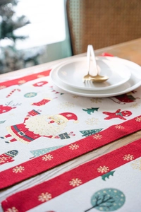Close-up of Jacquard Christmas placemat with Santa Claus pattern on a wooden table