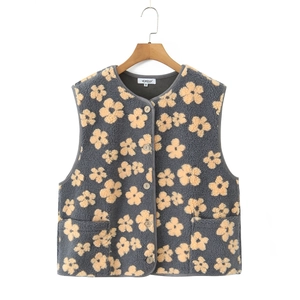 Detail shot of grey fleece vest with yellow floral pattern and soft lamb wool texture