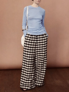 Retro light blue long-sleeved textured knit top with black and white checkered trousers