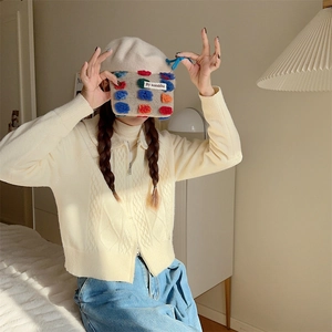 Detailed close-up of plush bucket bag texture with colorful dots and blue drawstring