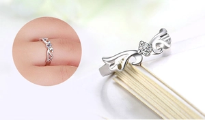 Detail of silver angel wing ring with a central round zircon stone for women