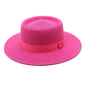 Rose pink straw boater sun hat with matching ribbon and flat brim for summer beach wear