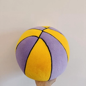 Detail of soft plush basketball pillow showing yellow and purple stitching and textures