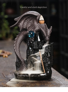Detail of dragon back with blue crystal bead and smoke flowing over ceramic castle