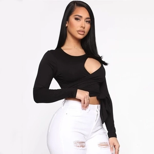Detail eines schwarzen langärmeligen Crop-Tops mit Zierausschnitt und Taillenschnürung