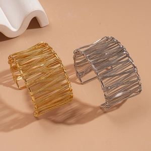 Set of gold and silver intertwining hollow wide cuff bracelets in minimalist metal style