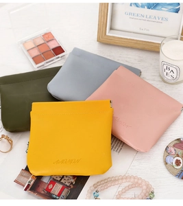 Flat lay of colorful PU leather pouches with snap closure for lipstick and accessories